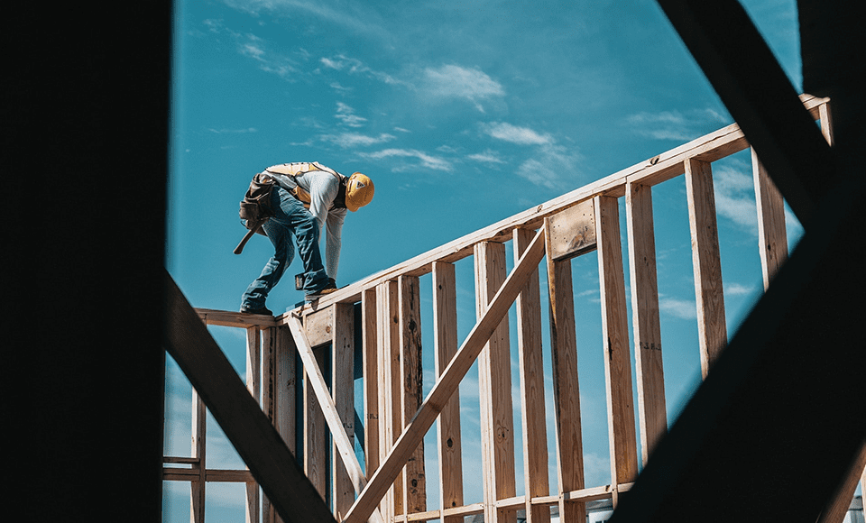 Construction Worker standing on wood panels